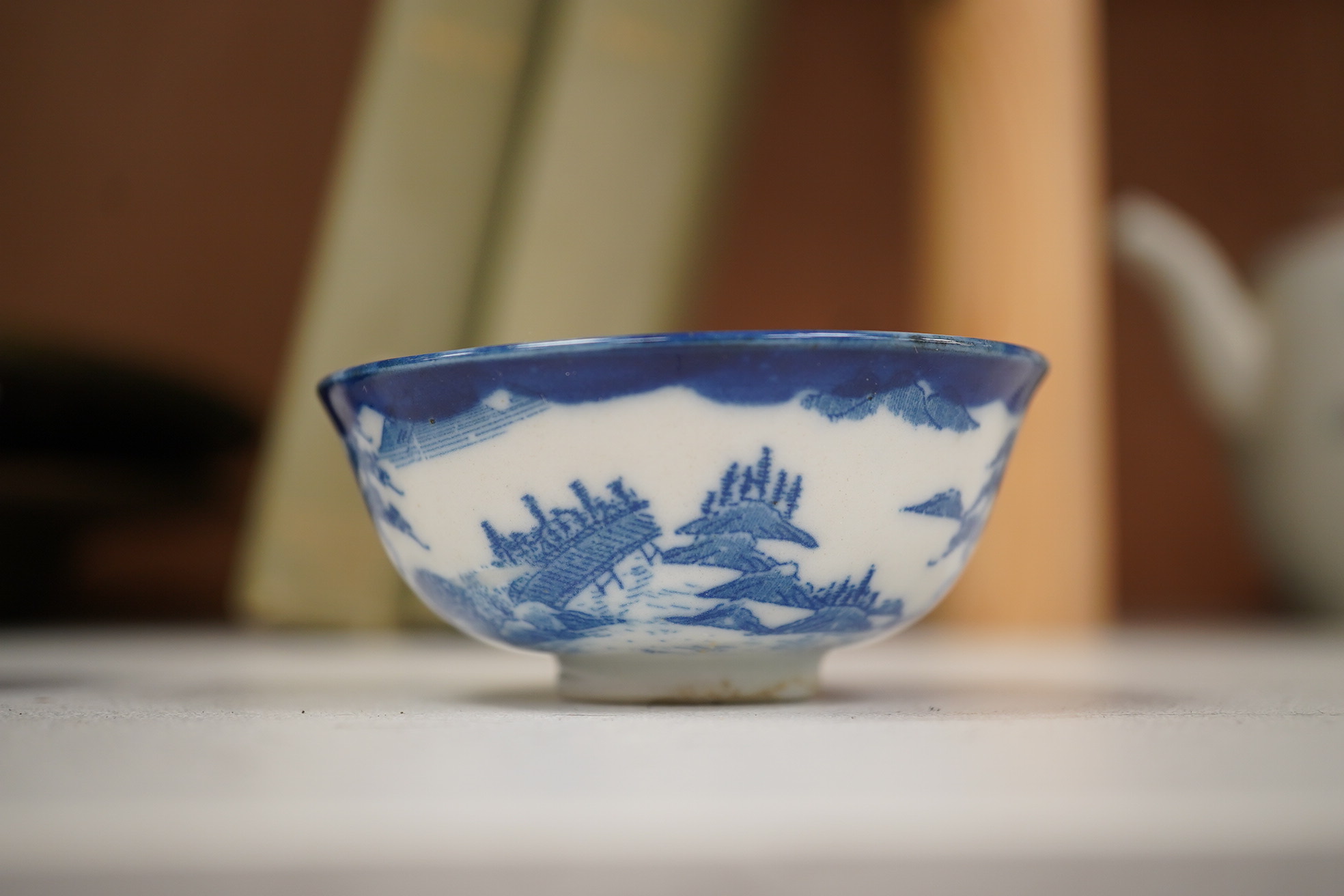 A group of Chinese blue and white porcelain, including a mid 19th century Canton enamel teabowl and a Japanese small dish, tallest 22cm. Condition - fair